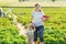 Mother and little boy of 2 years on organic strawberry farm in s