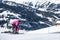 Mother and little child skiing in Alps mountains. Active mom and toddler kid with safety helmet, goggles and poles.