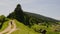 Mother and little child walking in afternoon on road in countryside. Mom and son walk in nature with mountains in background. Two