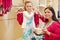 Mother and little daughter choose swimsuit