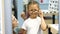 Mother with little daughter is choosing glasses at optics store