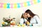 Mother and little daughter coloring Easter eggs