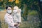 Mother and little daughter in medical masks in the autumn forest