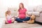 Mother and little daughter practicing yoga at home