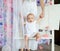 Mother with little daughter shake on swing in nursery.