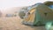 Mother with little daughter wakes up and looks out from tourist tent