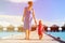 Mother and little daughter walking on beach report