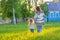 Mother and little daughter walking in sunny park