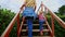 Mother Little Girl Climb up Stairs in Hedge Labyrinth in Park