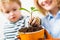 Mother with little son planting flower. Family relationships. Care for plants. Gardening discovering and teaching.