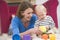 Mother in living room playing with baby