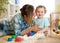 Mother in living room playing with smiling baby