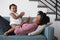 Mother Lying On Sofa At Home Playing Clapping Game With Baby Daughter