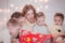 Mother with many children reads Christmas tales to children