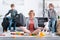 mother meditating in lotus position and smiling at camera while kids playing