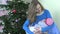 Mother mom breast feed infant baby near Christmas tree