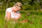 Mother nursing baby on meadow