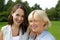 Mother and older daughter smiling together