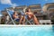 Mother in pareo and son sitting on beach chair