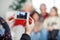 Mother Photographing Family Through Smartphone