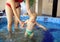 Mother play with her lovely child in jacuzzi
