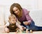 Mother playing with alphabet blocks with her son