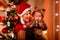 Mother playing with baby near Christmas tree