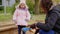 Mother playing with her daughter in a sandbox