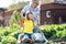 Mother playing with kid in garden in village