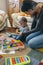 Mother playing with toddler a wooden game building