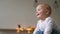 Mother plays with Baby in a white t-shirt lying on the bed, a child flies and laughs