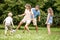 Mother plays football soccer with family