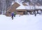 Mother plays with son on snowbank