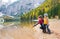 Mother pointing and kneeling next to daughter at Lake Bries