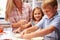 Mother preparing pizza with kids