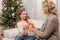 Mother presenting gift to daughter