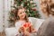 Mother presenting gift to daughter