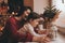 Mother and pretty daughter decorating they home with Christmas decoration. Cute little girl and her beautiful mom decorating with