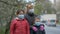 Mother in protective glasses adjusts her daughter`s medical mask on the street of a European city .  The concept of protection