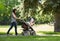 Mother Pushing Baby Carriage In The Park