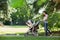 Mother Pushing Stroller In The Park