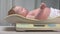 Mother puts baby on scales to be weighed