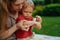 Mother puts cream on baby\\\'s hand