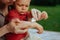 Mother puts cream on baby\\\'s hand