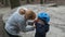 Mother puts on a medical mask for her son before Cycling in the Park. The concept of protection FROM covid-19 coronavirus