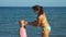 Mother Putting Sunscreen on Little Daughter Face