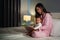 mother read story in the book for infant baby on bed at night