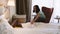 Mother is reading book while child is slipping in hotel