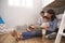 Mother Reading Story To Children In Their Bedroom