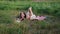 Mother Reading Tales for Daughter in Summer Field